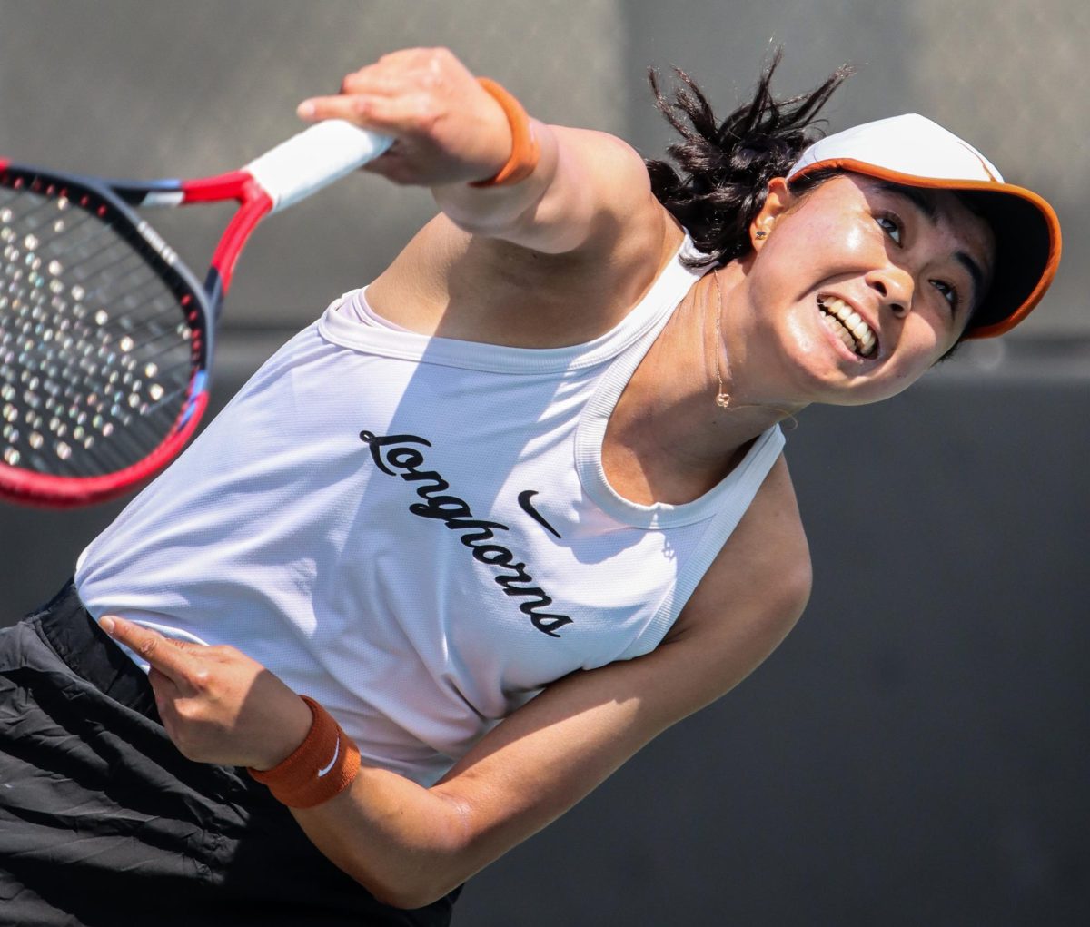 Senior Charlotte Chavatipon serves the ball during singles play against Oklahoma on March 3, 2024.