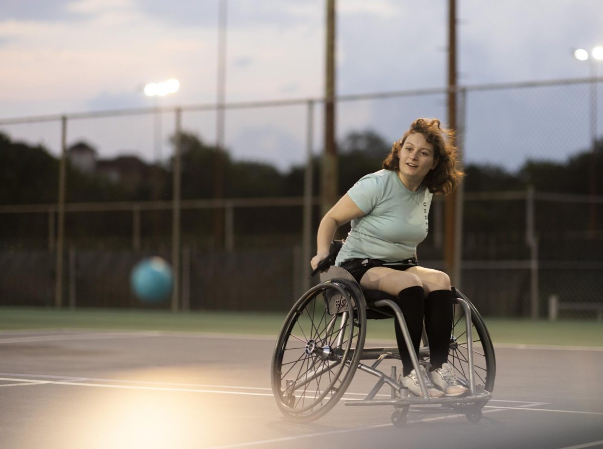Third-year+psychology+major+Cooper+Madison+plays+pickleball+while+using+a+wheelchair+on+Monday.+The+DCC%2C+in+partnership+with+Austin+Adapted+Sports%2C+leads+the+sessions+every+Monday+evening+at+Whitaker+Fields.