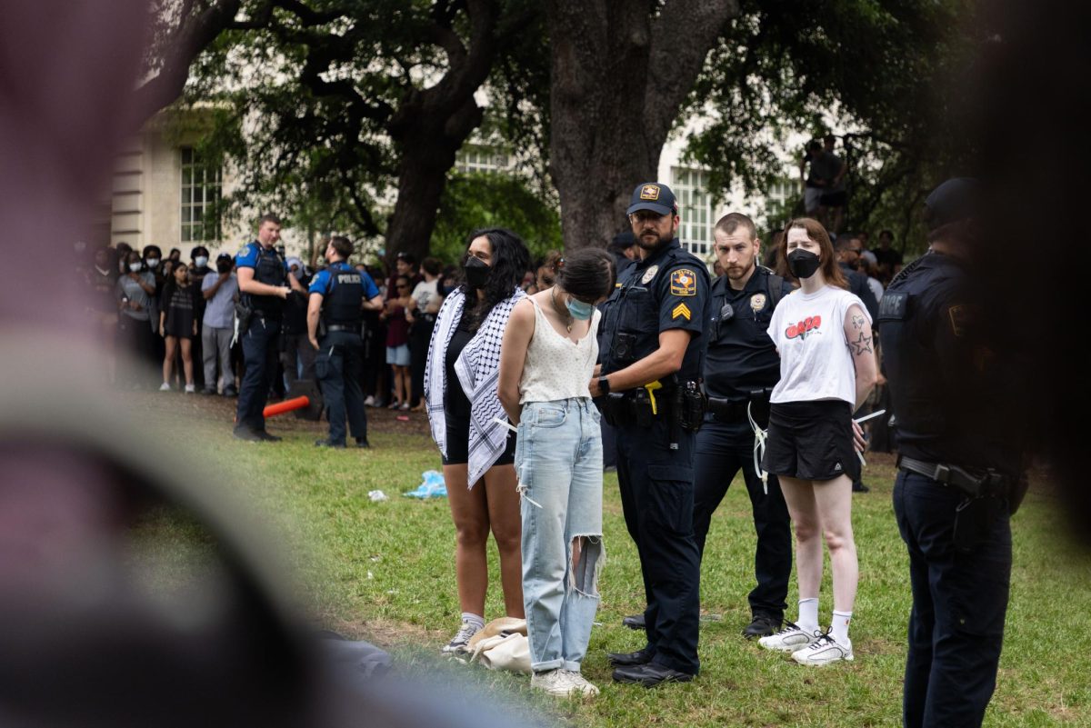 Protesters+stand+as+they+are+arrested+during+a+protest+on+the+University+of+Texas+campus+on+April++24%2C+2024.