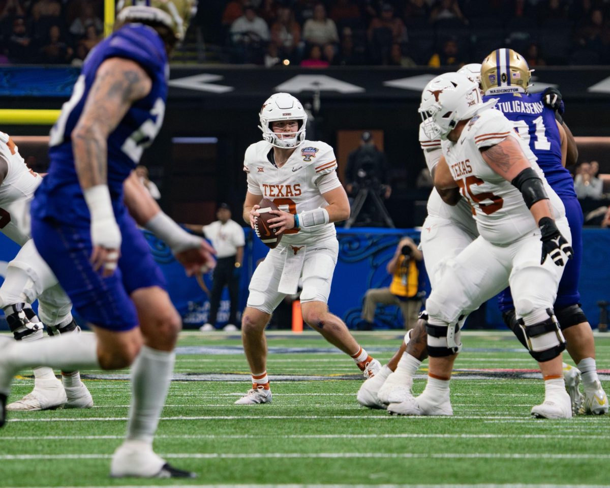 Quarterback Quinn Ewers looks to pass the ball during the College Football Playoff game against Washington on Jan. 1, 2024. 