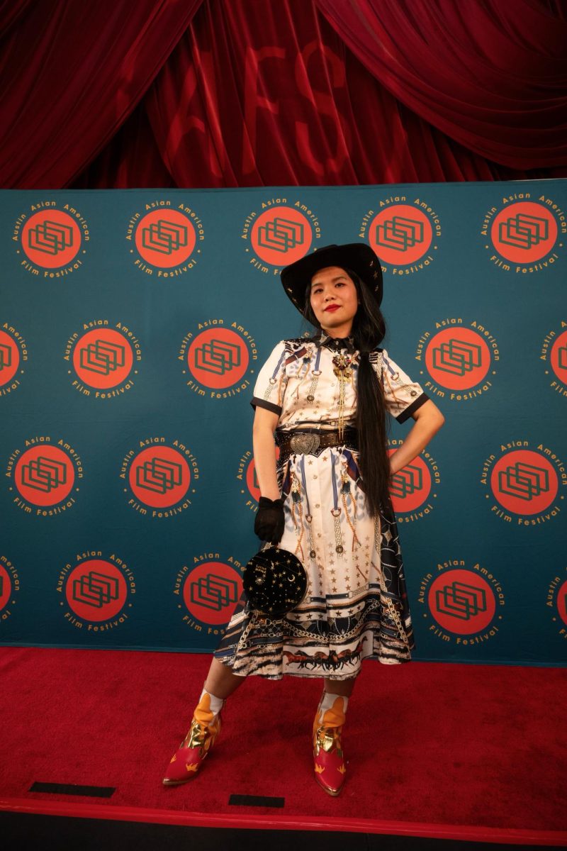 Artist Tsz Kam stands for a portrait at the Austin Asian American Film Festival red carpet on Friday. Tsz designed the this year’s iteration of the festival poster.