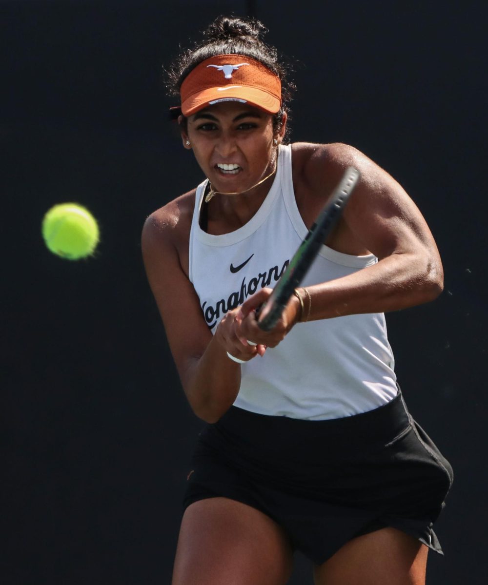 Senior Malaika Rapolu hits the ball during singles play against Ava Catanzarite of Oklahoma on March 3, 2024. Rapolu earned Texas first win of the match with a 6-2, 6-2 victory over Catanzarite.