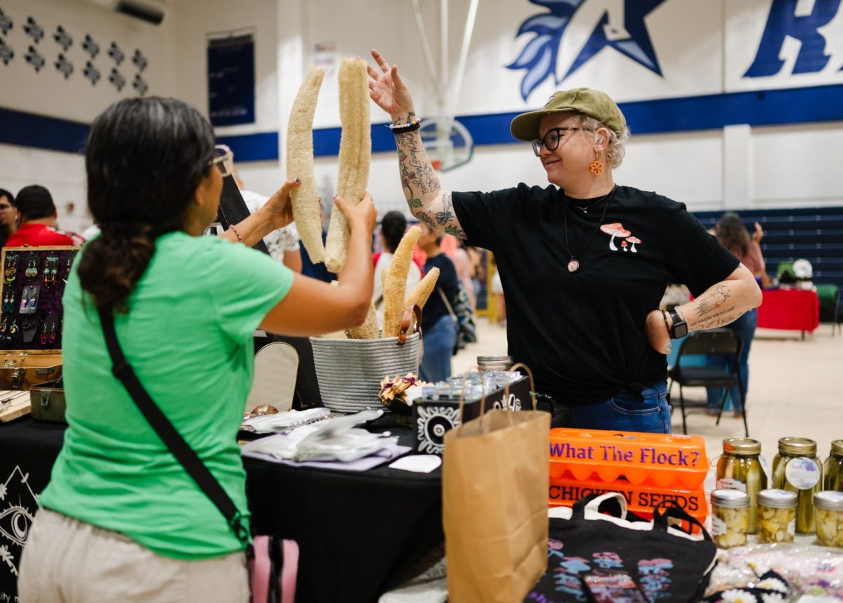 Lisa Dang-Bromley, the founder of Deaf Artisan Market Day (DAMD), sells crafts under her brand Moon Dang at the DAMD event in Texas School for the Deafs Seeger Gym on July 9, 2024.