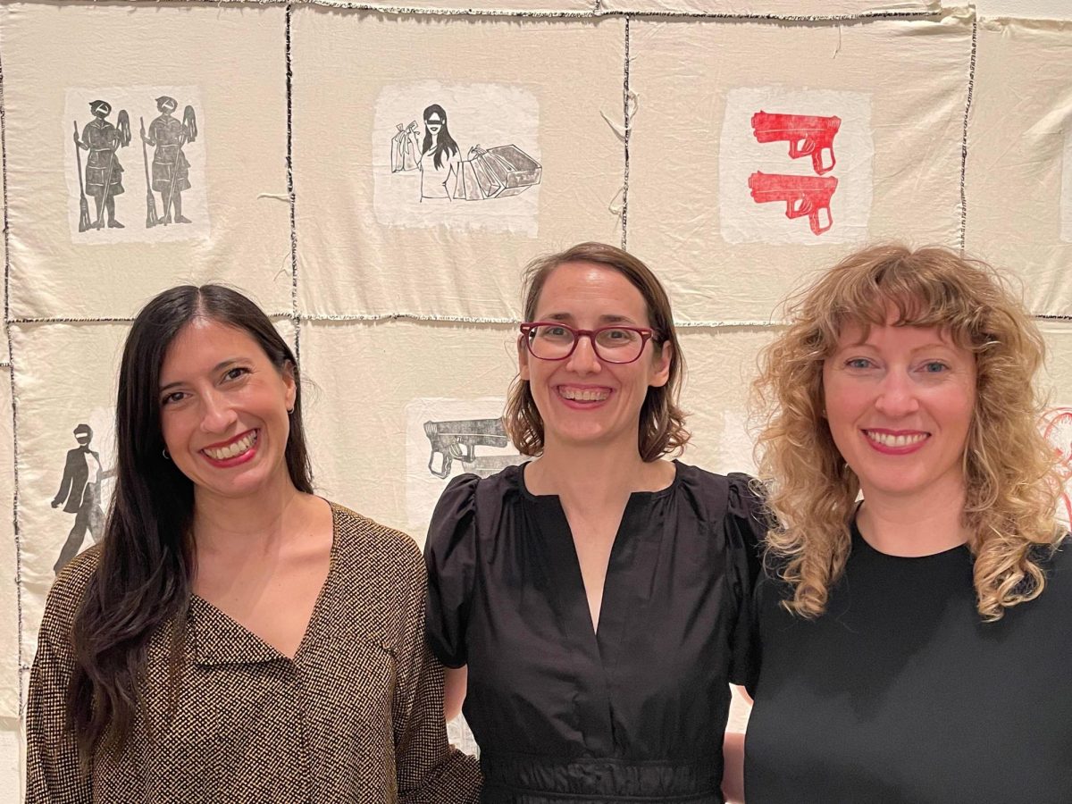 From left to right, Maria Emilia Fernandez, Dr. Adele Nelson and MacKenzie Stevens in front of artwork from exhibit.