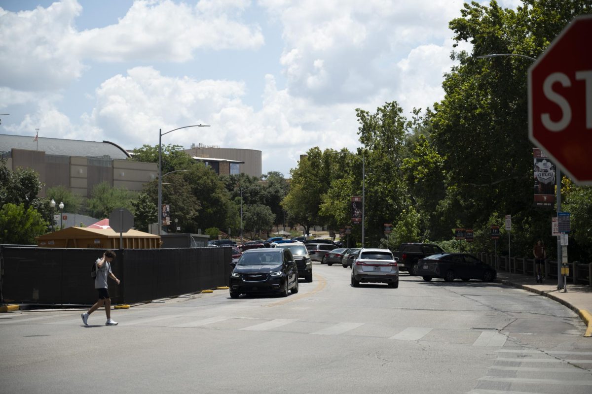 A pedestrian crosses the street on  San Jacinto Boulevard on UT's campus on Sunday, August 25, 2024.