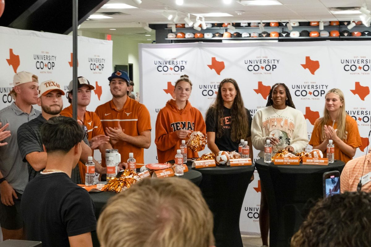 Texas student athletes applaud following a donation to an organization supporting students during the Co-Op renovation celebration on Aug. 23, 2024. 