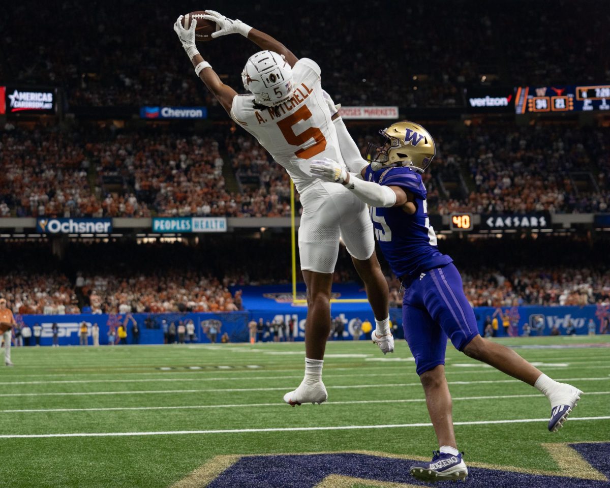 Wide receiver Adonai Mitchell completes a catch and a touchdown during the Allstate Sugar Bowl game against Washington on Jan. 1, 2024.