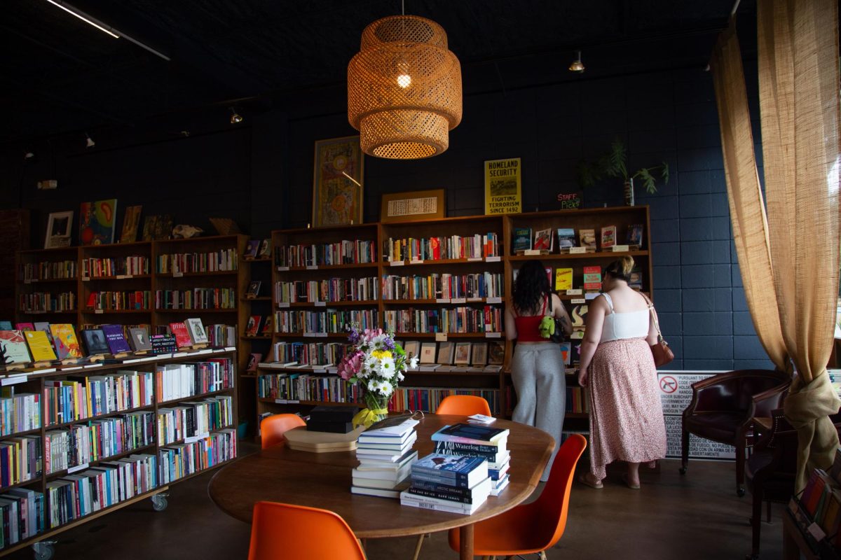 Two customers look at Alienated Books' "staff picks" section on Aug. 29, 2024.