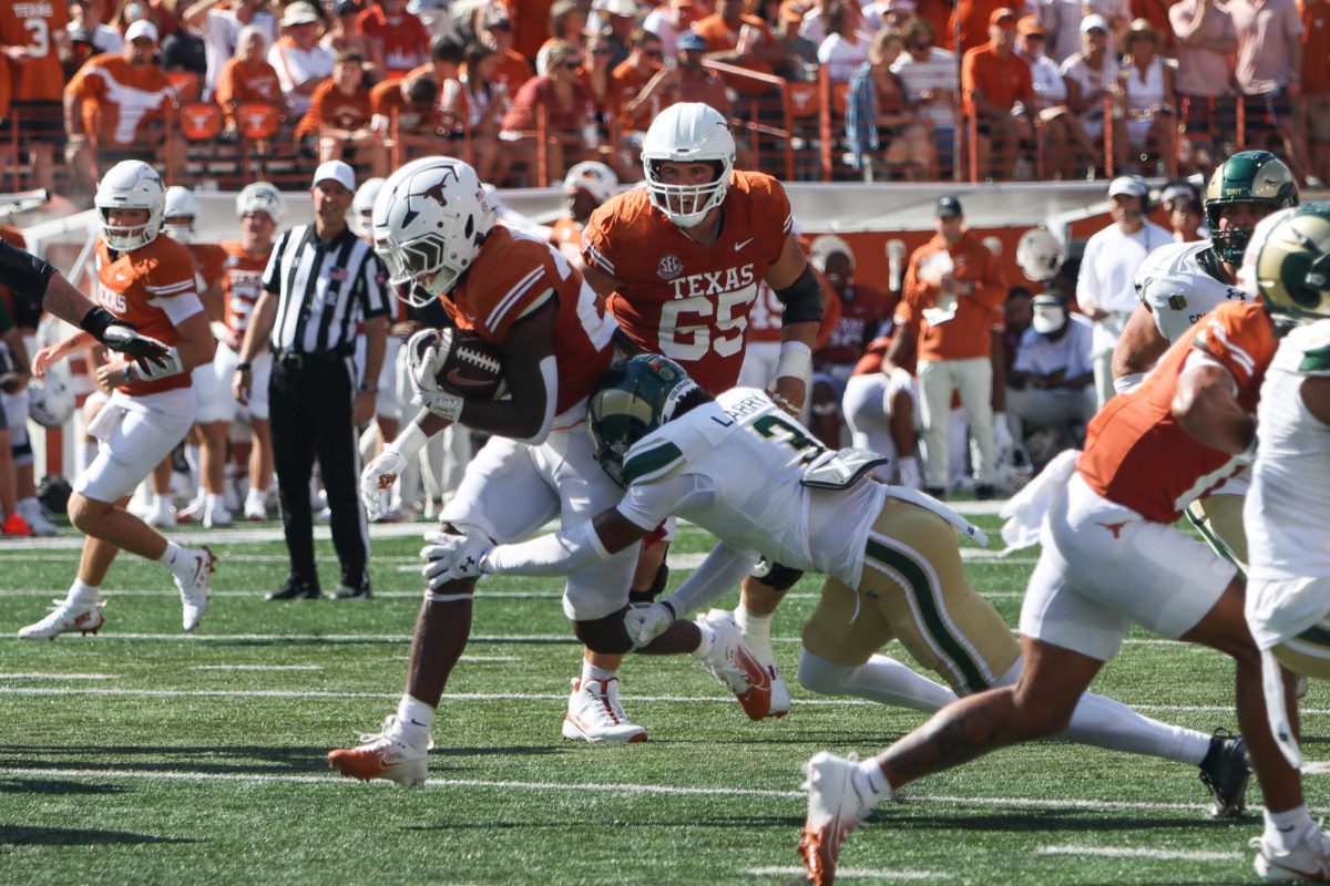 Running back Quintrevion Wisner gets tackled while running with the ball in the second quarter of the game against Colorado State on Saturday.