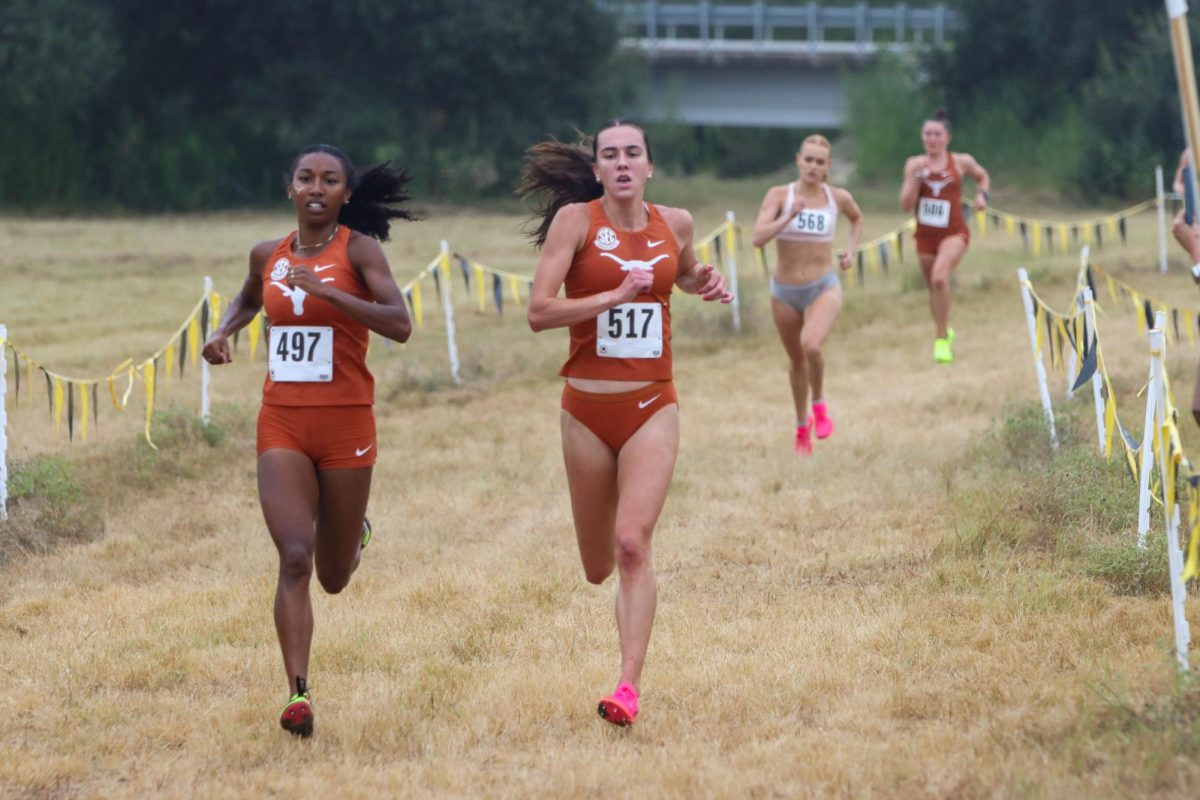 Olivia Howell (left) and Elizabeth Stockman run to the finish line at the Stormy Seas Opener on Aug. 30, 2024. Howell finished in first place with a time of 17:15.