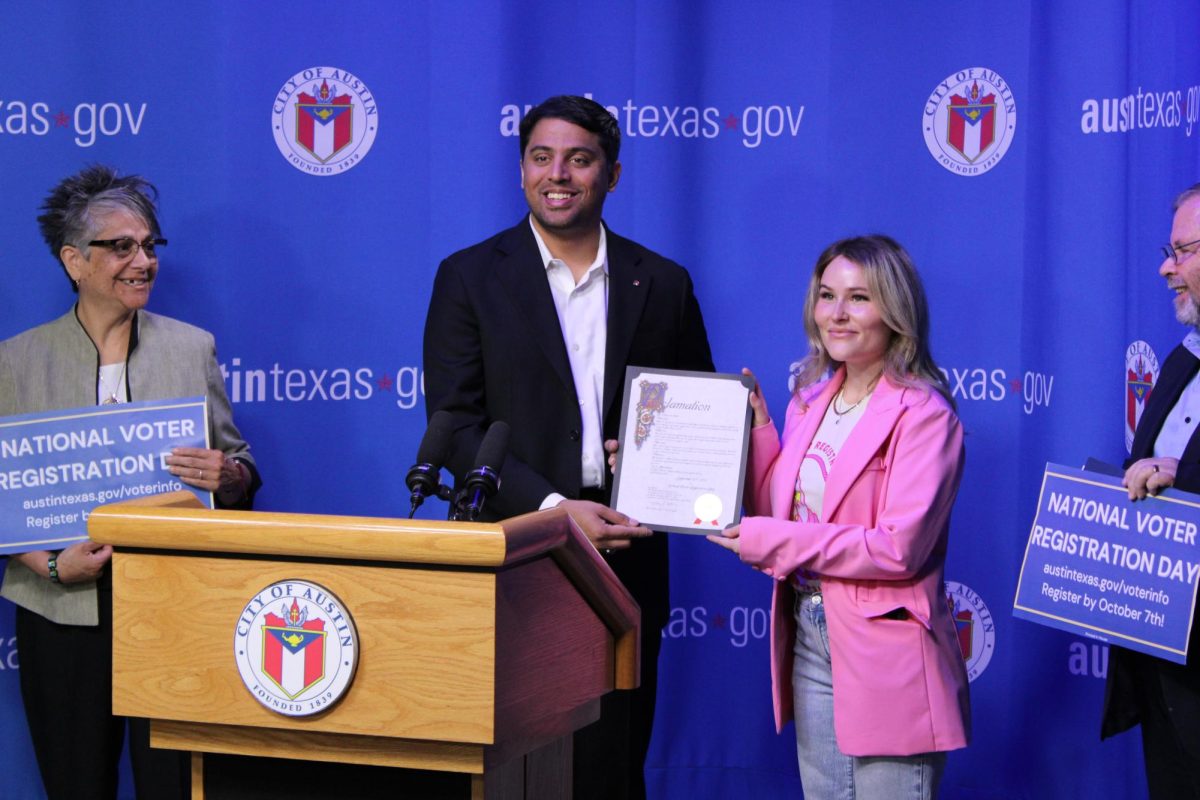 Austin District 9 Councilman Zo Qadri presents a national voter registration day proclamation on Sept. 17 to a representative from Move Texas.