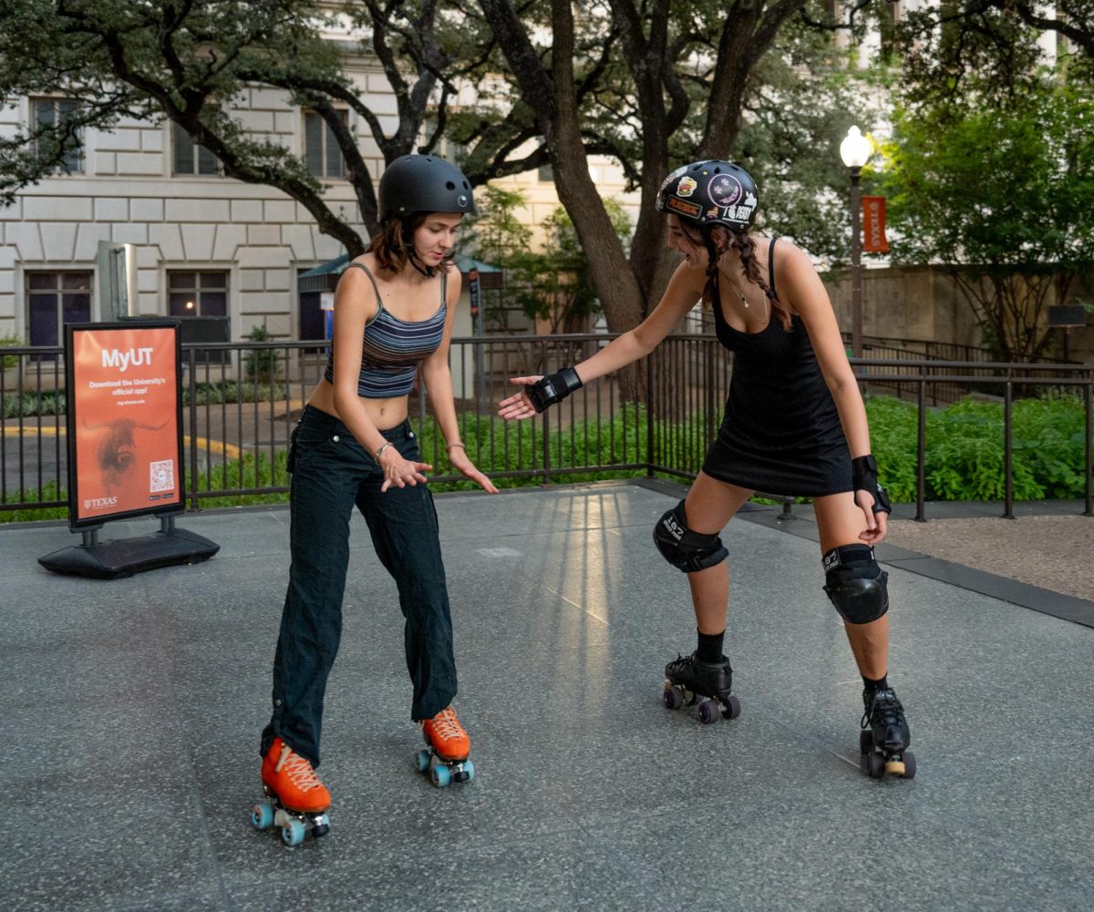 Co-founders of the All Girls Skate Club, Olivia Snelgrove (left) and Adriana Garris (right) skate around the Flawn Academic Center on Sept. 21, 2024. The two hope to unite all types of female skaters by practicing together as a community.