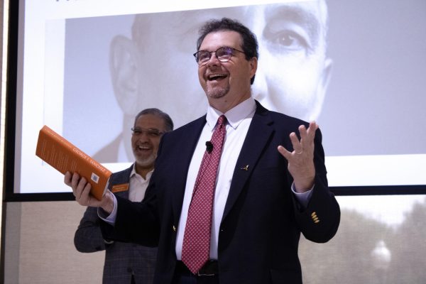 Author and professor Dr. Carlos Kevin Blanton hands out raffled books after his presentation on his book "George I. Sanchez: The Long Fight For Mexican American Integration" at Elizabeth Shatto Massey Honor Hall on September 24th. The book is a biography of the life of George I. Sanchez and the impact he had on improving the lives of Mexican Americans.