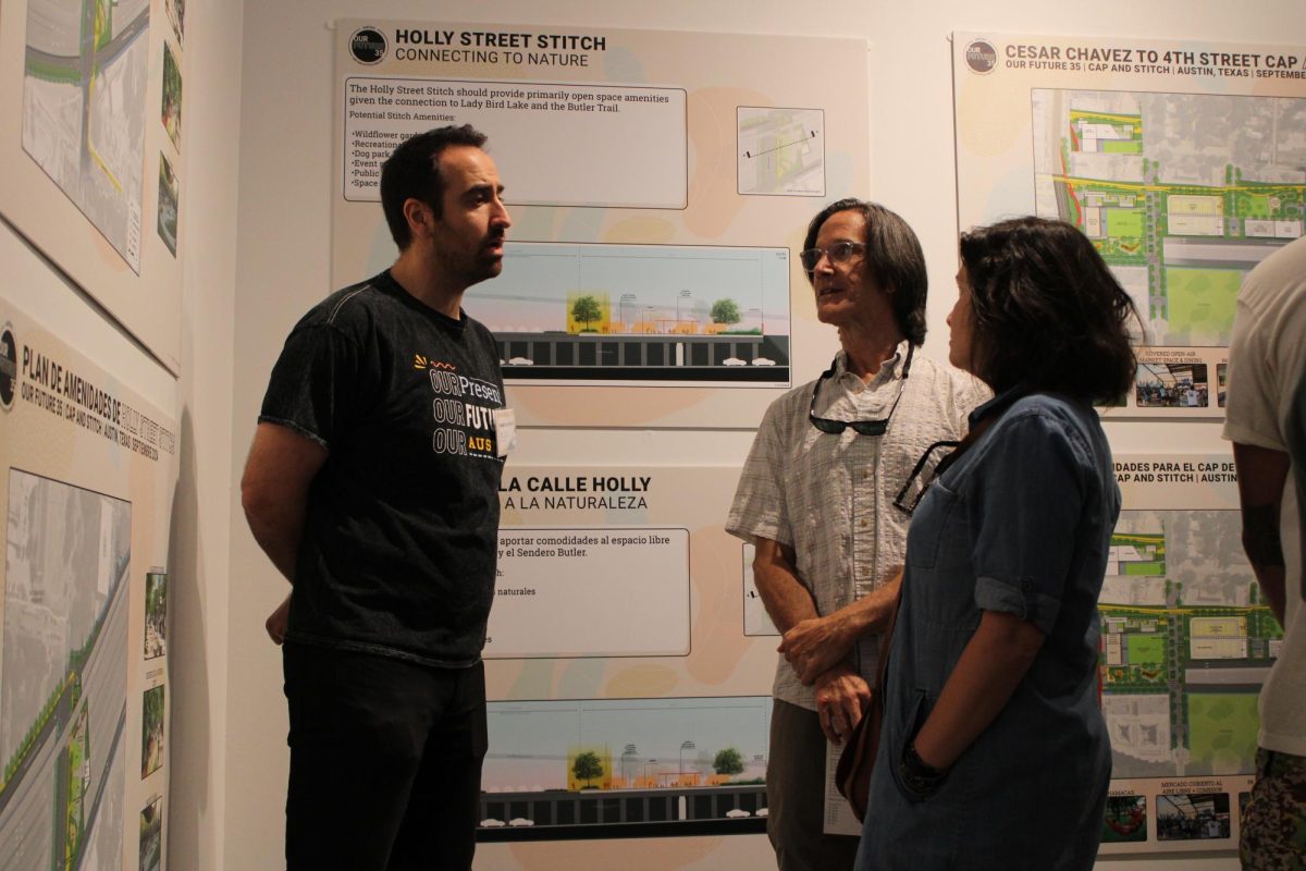 City of Austin Transportation and Public Works employee Sadra Dehghan talks with two attendees about proposed changes to Interstate 35 in Austin at a community meeting on Sept. 28, 2024. Dozens of individuals involved with the planning process were present to answer questions about the project.