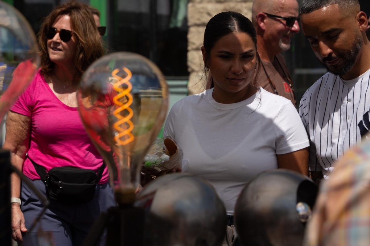 People browse vendor Get Bent Metal Works at Pecan Street Festival in downtown Austin on Saturday, Sept. 14, 2024. Artist Shawn Corder sculpts everything from robots, to lamps, to abstract decor.