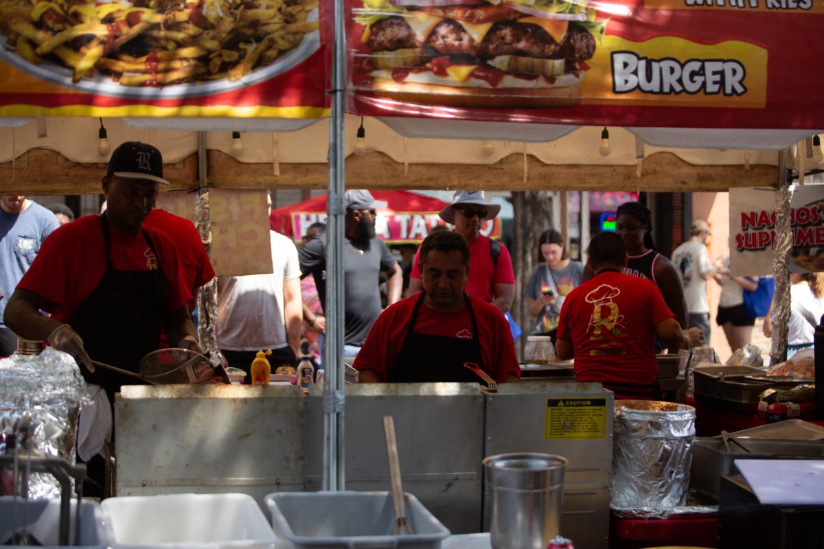 R.A.R. Grill food service workers cook for festivalgoers at Pecan Street Fest on Saturday, Sept. 14, 2024 in downtown Austin. The vending and catering company serve a variety of food ranging from funnel cakes to Philly Cheesesteaks.