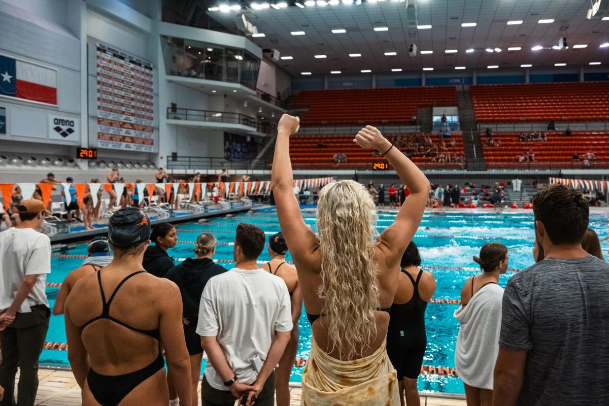 The men's and women's swim & dive teams cheer as their teammates compete against the University of Houston on Oct. 6, 2023.