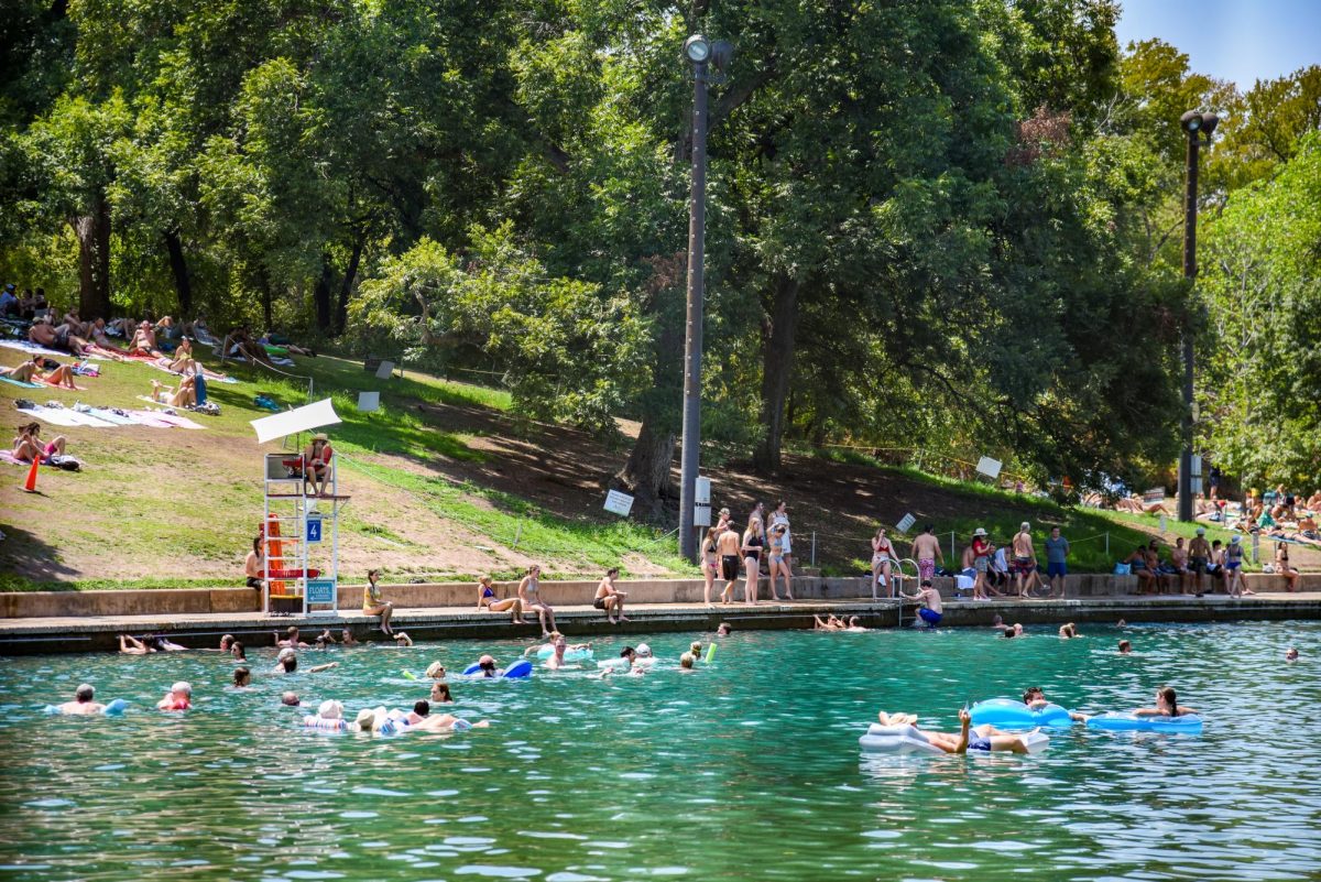 People relax in Barton Springs on Aug. 28, 2023.