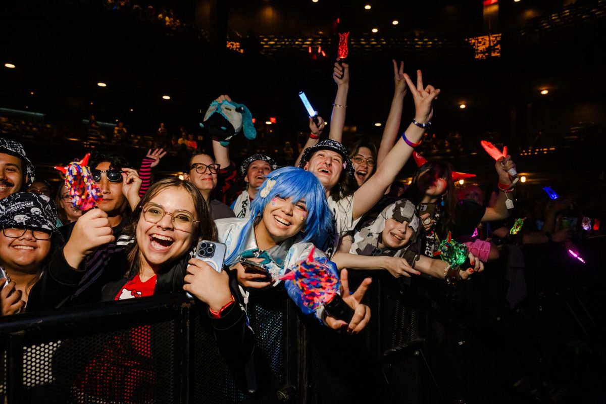 Mars (blue wig), a fan of Japanese vocaloid artist Kikuo, poses for a portrait with other fans before his set at ACL Live at the Moody Theatre Sunday. Along with many others, Mars cosplayed as Hatsune Miku, a vocalic voicebank character that Kikuo incorporates into his videos and music.