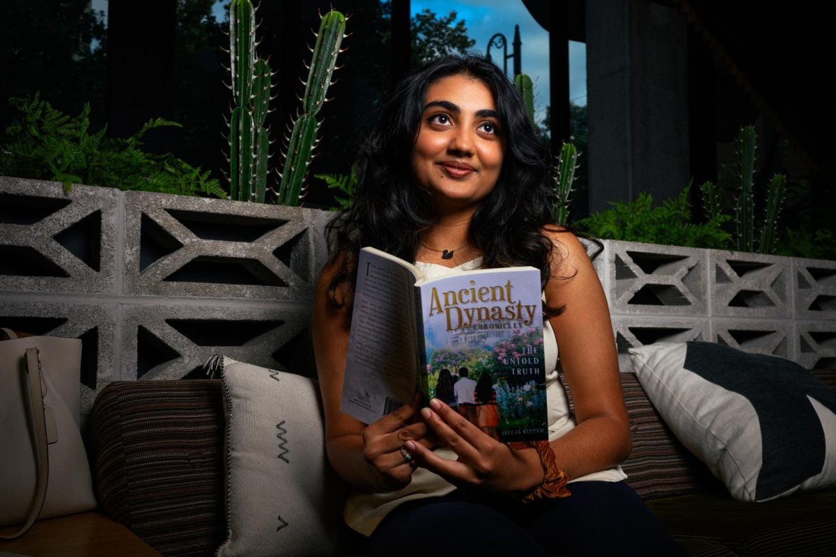 Plan II Honors and Informatics Junior Sreeja Kuppam poses for a portrait with her first book, "Ancient Dynasty Chronicles: The Untold Truth" at the Waterloo Lobby in West Campus where she regularly works and writes on Sept. 10, 2024.