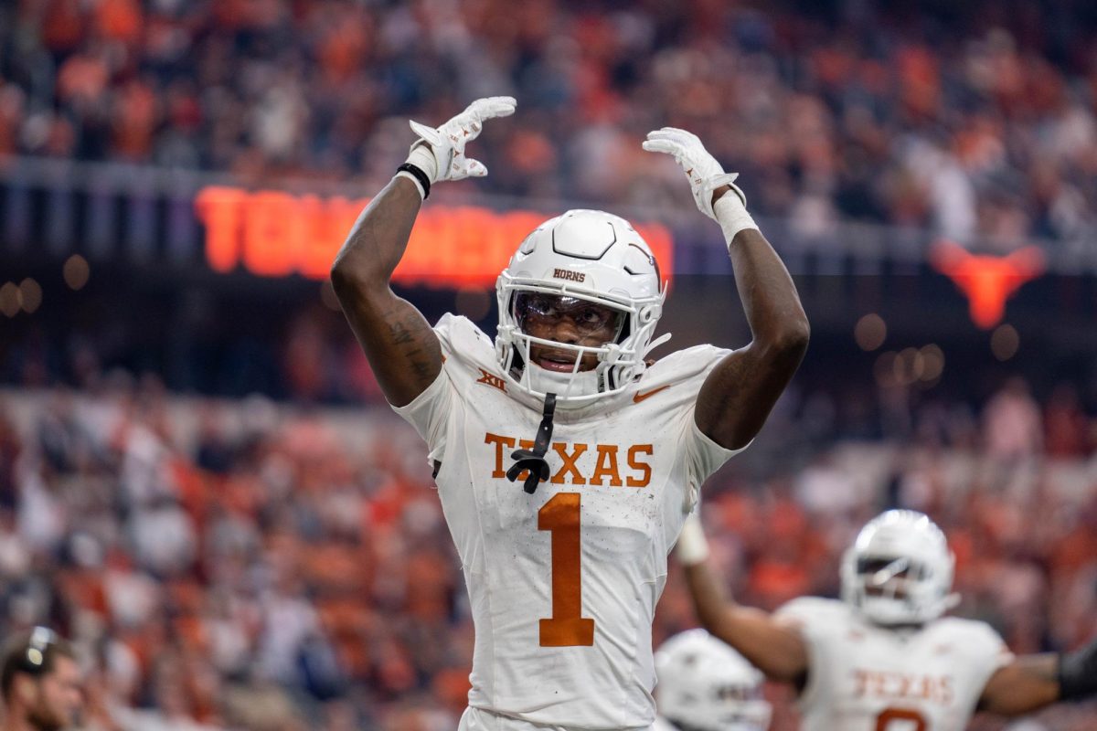 Former wide reciever Xavier Worthy motions for the crowd to cheer at the 2023 Big 12 Championship game on Dec. 1, 2023. Texas beat Oklahoma State 49-21.