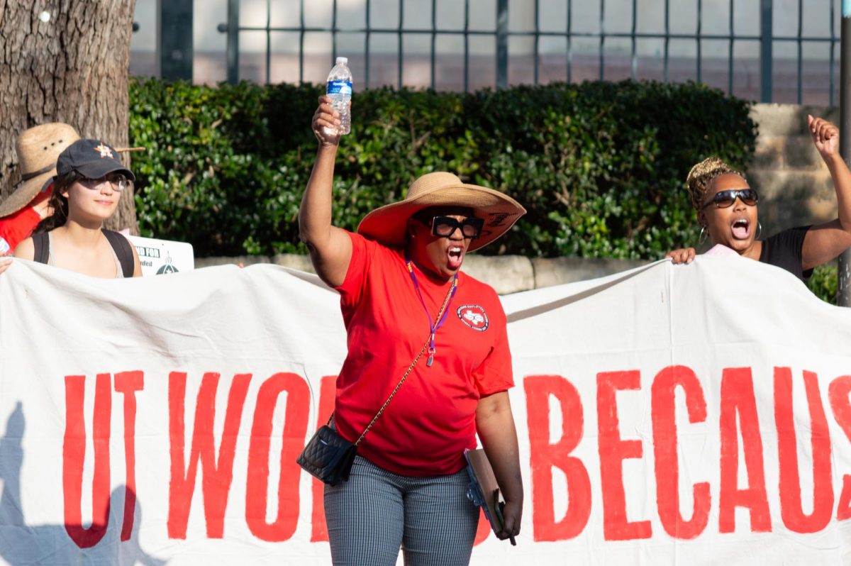 A member of the Texas State Employees Union Local 6186 leads a chant at the group’s rally for pay raises for university workers on Sept. 13, 2024. The rally began at the West Mall and slowly moved up Guadalupe Street while cars that drove by honked in support.