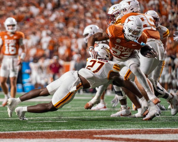 Running back Jaydon Blue is tackled by a defender during Texas' game against ULM on Sept. 21, 2024. 