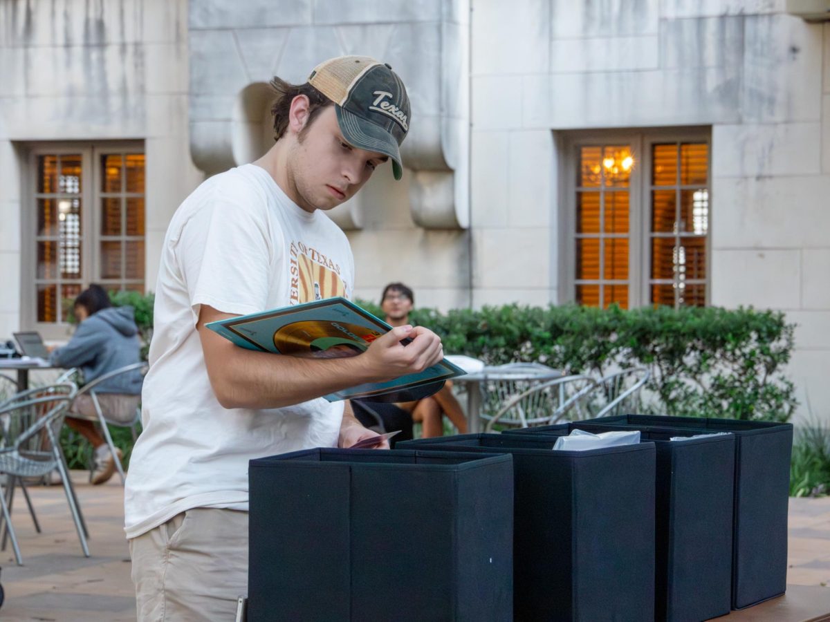 UT senior Jake Aiger looks at records at the Headliners Exchange event in the East Patio of the Union on Sept. 25, 2024.