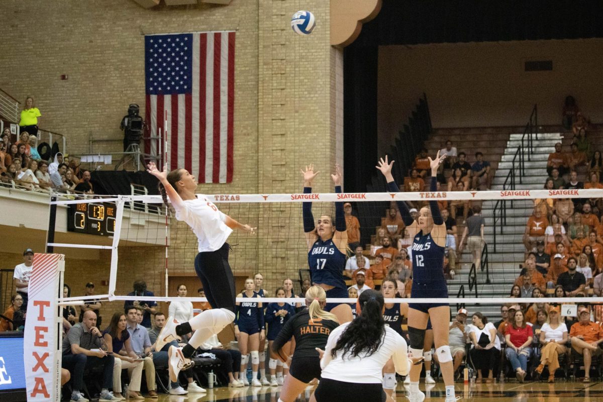 Junior Madisen Skinner hits the ball over the net durig the game against Rice on Sept. 11, 2023. 