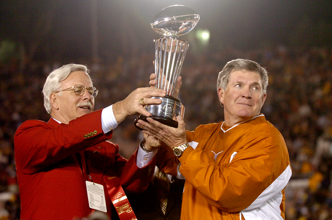 Texas head coach Mack Brown hoists the Rose Bowl trophy after a 38-37 win over Michigan in 2005.