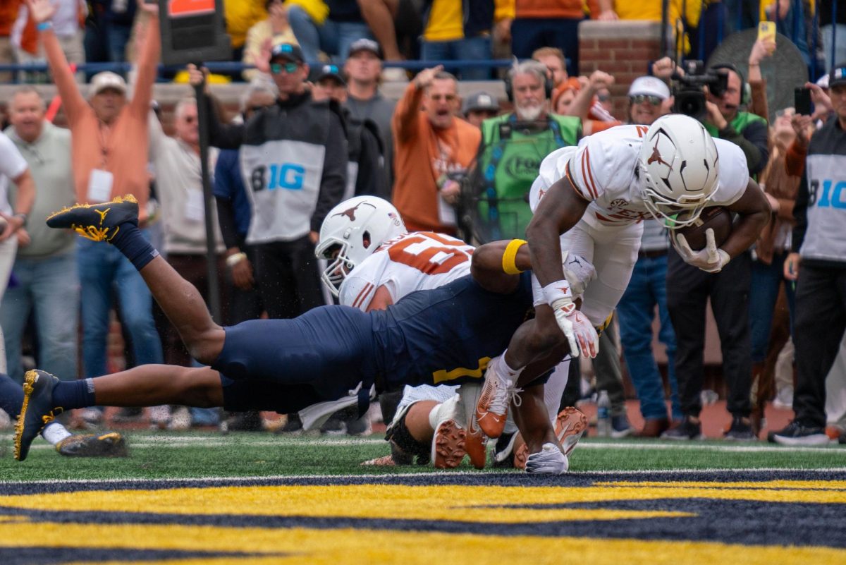 Running back Jerrick Gibson scores a touchdown during Texas' game at Michigan on Saturday.