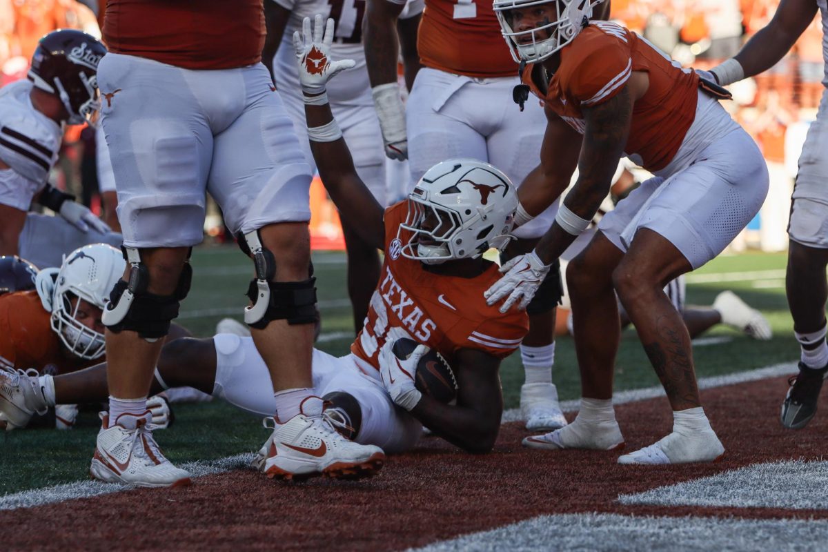 Running back Quintrevion Wisner raises his hand after landing in the end zone on Sept. 28, 2024.