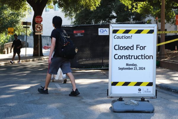 Students walk past construction zones on Inner Campus Drive near Batts Hall on Oct. 1, 2024. The project aims to provide a reliable and accessible route to navigate the campus terrain, according to UT project details.