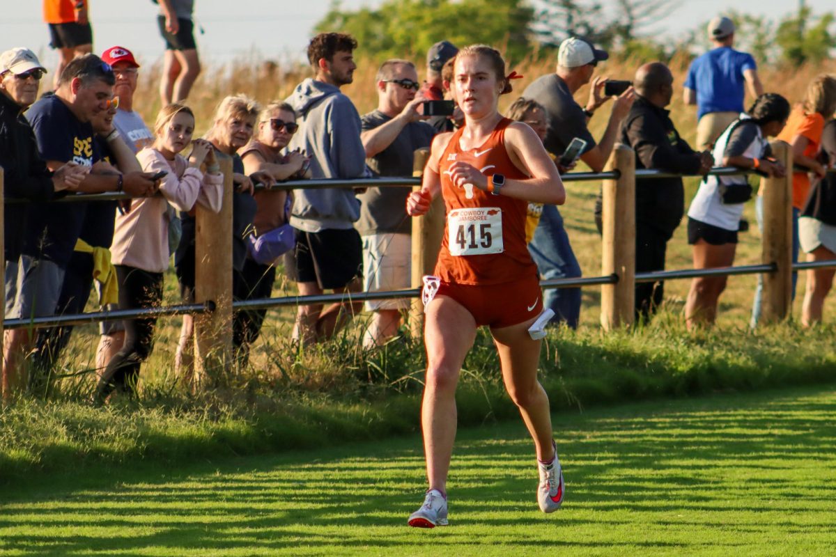 Eva Jess runs down the final stretch of the 6000-meter course at the Cowboy Jamboree on Sept. 23, 2023.