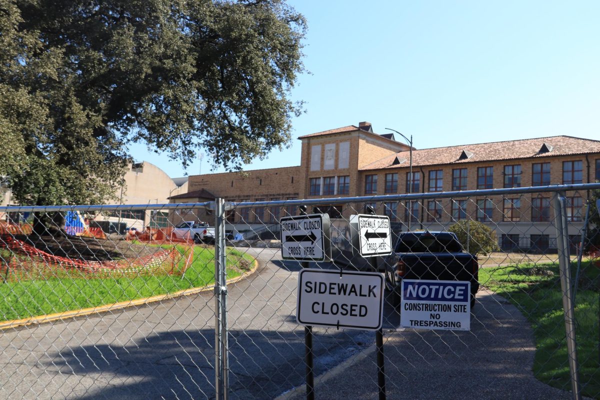 Construction fences stand in front of the Steve Hicks School of Social Work Building on Monday, Oct. 7.