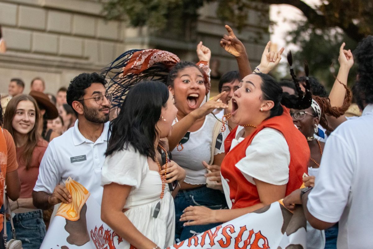 Students in Texas Orange Jackets/ Blazers celebrate after winning the spirit competition. The spirit group won $1000 for showing the most spirit during the Texas Fight Rally Parade on Oct. 9, 2024.