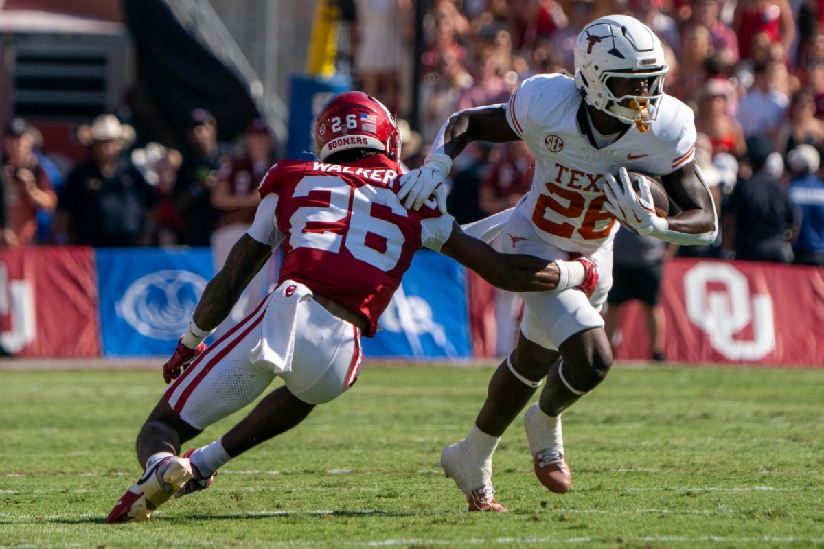 Running back Quintrevion Wisner runs past Oklahoma defensive back Kani Walker during the Red River Rivalry game on Oct. 12, 2024. 