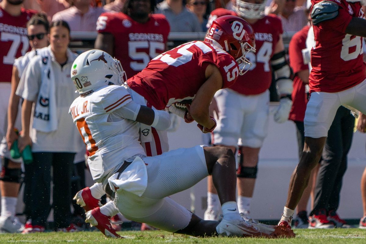 Sophomore linebacker Anthony Hill Jr. tackles Oklahoma wide receiver Brenen Thompson during the Red River Rivalry game on Oct. 12, 2024.