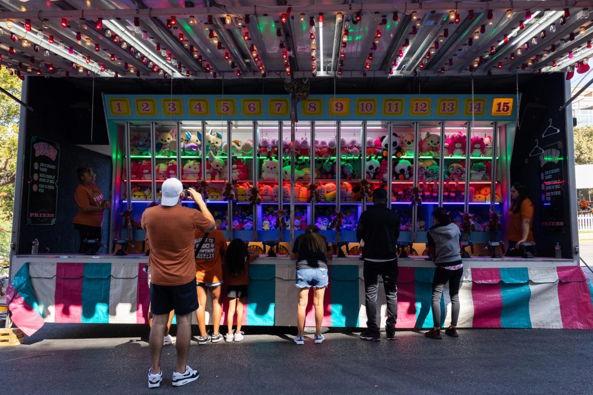 Fans play carnival games at Smokey's Midway before the Texas v Georgia game on Oct. 19, 2024.