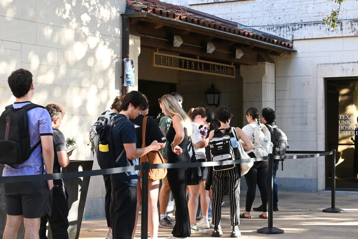 Students wait in line to early vote at the Texas Union late afternoon on Oct. 22, 2024.