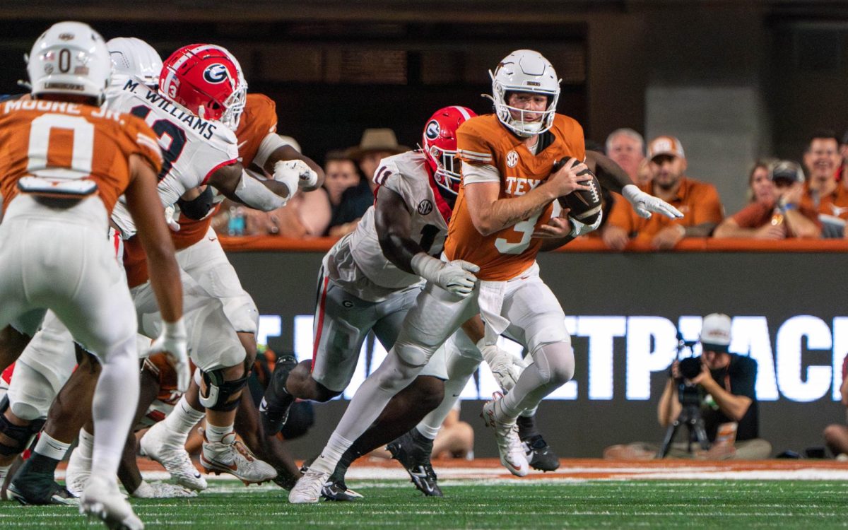 Quarterback Quinn Ewers runs from a defender during Texas' game against Georgia on Oct. 19, 2024. 