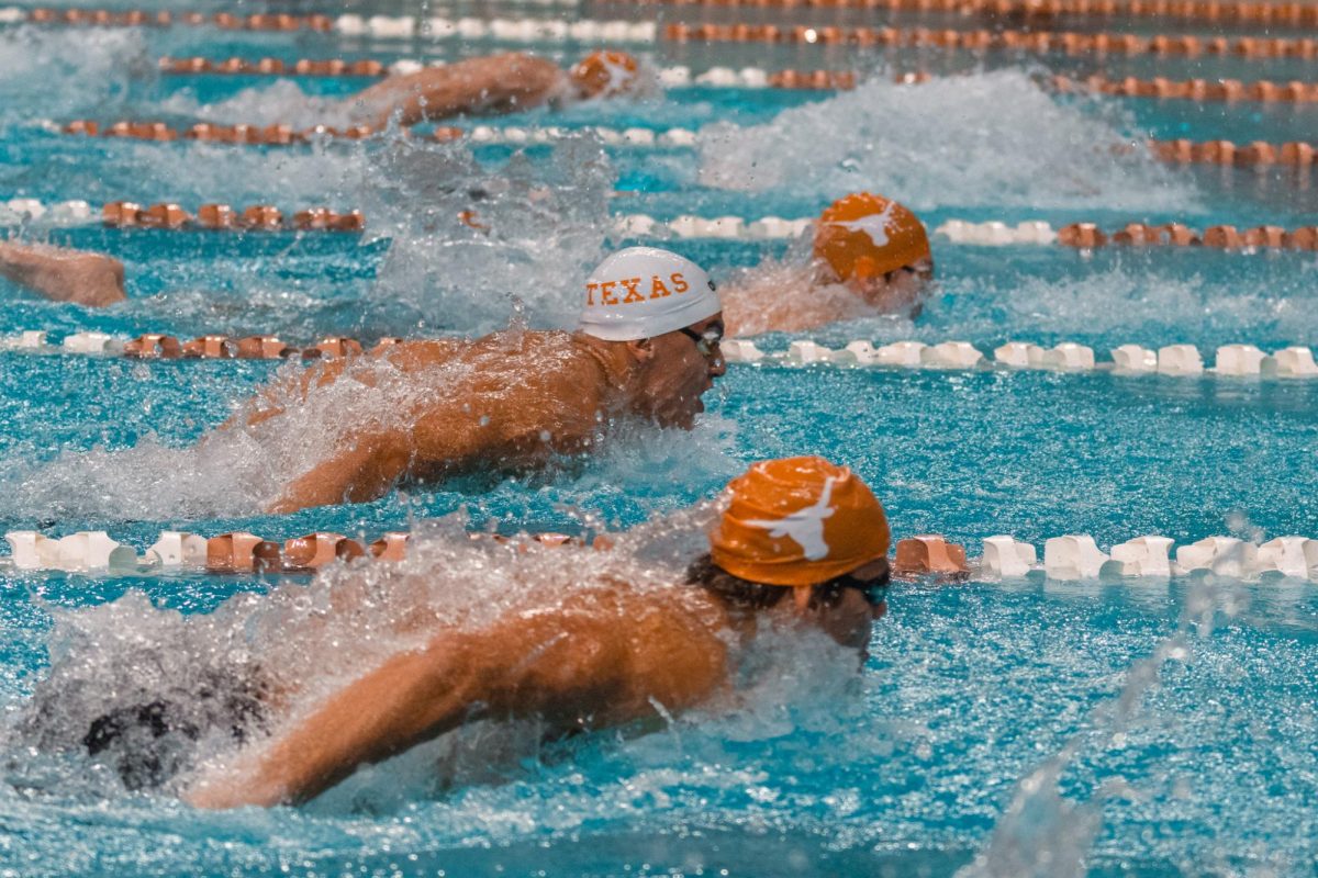 Members of the UT Men's Swim Team come up for air during their first meet on Oct. 3, 2024.