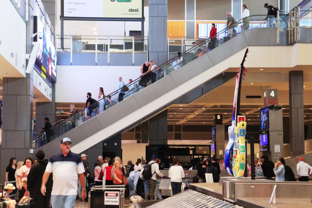 Passengers take the escalator to collect their luggage at the Austin-Bergstrom International Airport on Oct. 27.