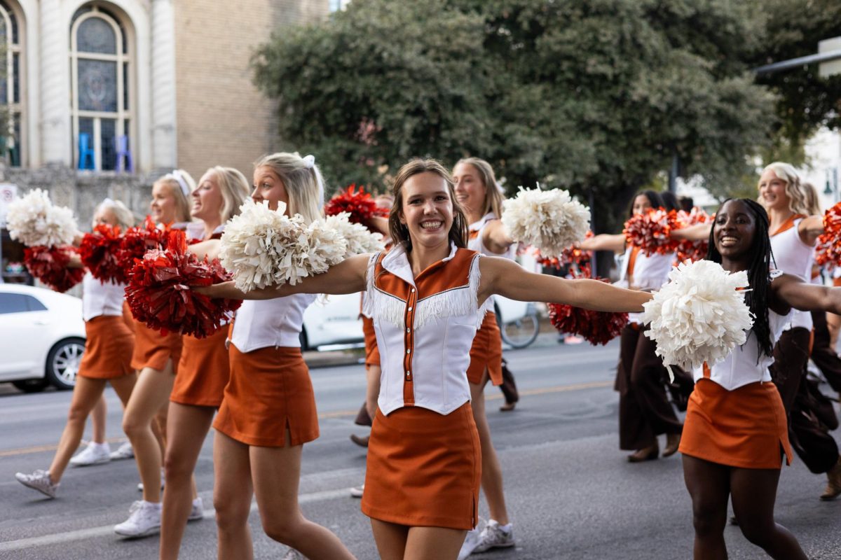 A member of the spirit squad poses as they walk down Guadalupe Street for the Texas Fight Rally on Oct. 9, 2024.