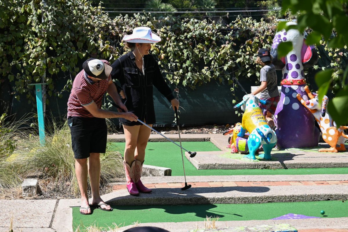 Two adults play mini-golf at Peter Pan Mini-Golf on Oct. 9, 2024.