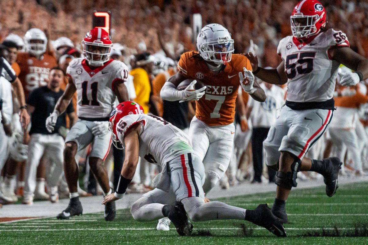 Defensive back Jahdae Barron runs the ball towards the end zone after intercepting a pass from Georgia quarterback Carson Beck during Texas' game against the Bulldogs on Oct. 19, 2024.  