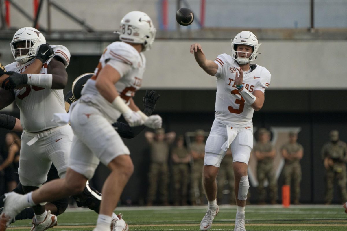 Quarterback Quinn Ewers throws a pass to tight end Gunnar Helm during Texas' game against Vanderbilt on Oct. 26, 2024. 