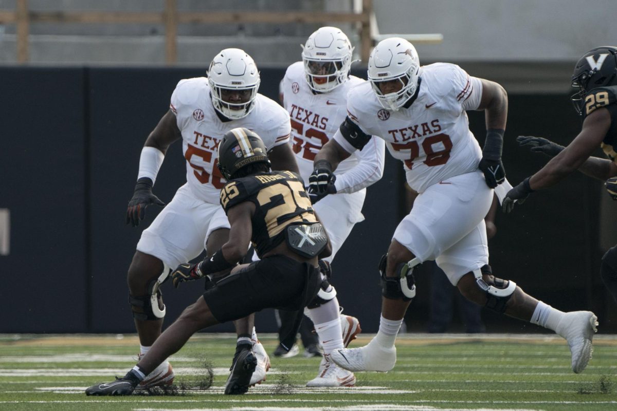 Offensive lineman Cameron Williams (left), DJ Campbell (middle) and Kelvin Banks Jr. (right) prepare to tackle Vanderbilt cornerback Martel Hight after he intercepted a pass from Quinn Ewers during Texas' game against the Commodore's on Oct. 26, 2024. 