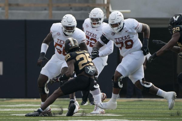 Offensive lineman Cameron Williams (left), DJ Campbell (middle) and Kelvin Banks Jr. (right) prepare to tackle Vanderbilt cornerback Martel Hight after he intercepted a pass from Quinn Ewers during Texas' game against the Commodore's on Oct. 26, 2024. 