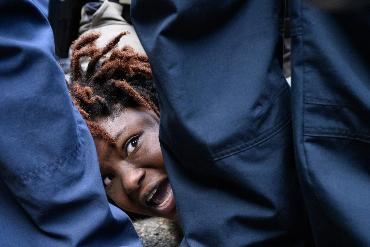 Law enforcement detain and zip-tie a student demonstrator on the UT Main Mall pavement during the pro-Palestine student walkout on Wednesday, April 24, 2024. 